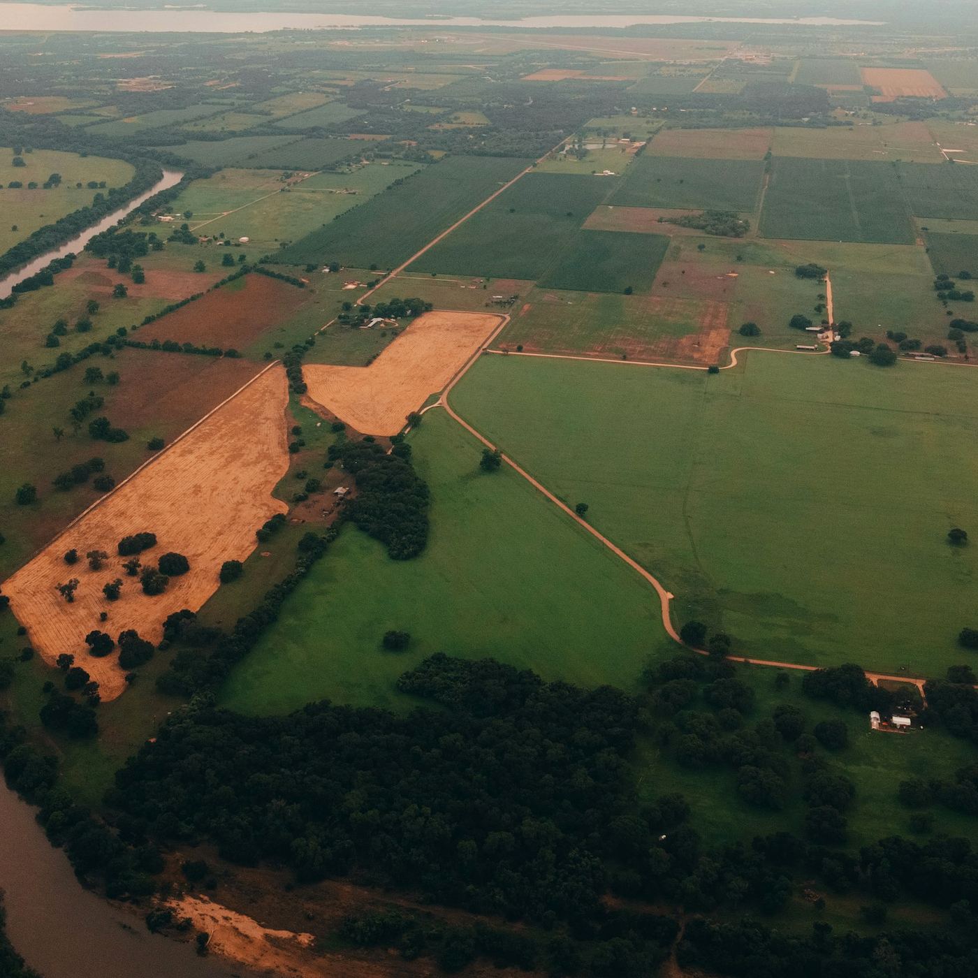 Aerial view of a river winding past farm fields near Waco, Texas